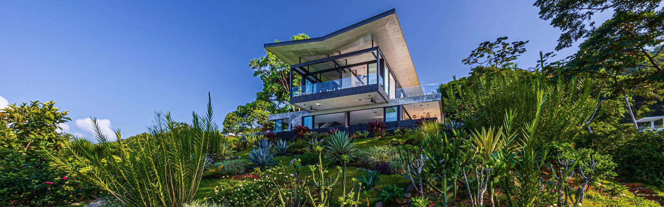 Hillside home in Dominical, Costa Rica, built on terraced retaining walls with views of the Pacific
